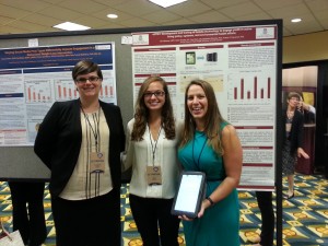 Elizabeth Renedo, Research Communications Manager for the Office of the Vice President for Research, with Gina Besenyi and Mara Steedley at their poster. 